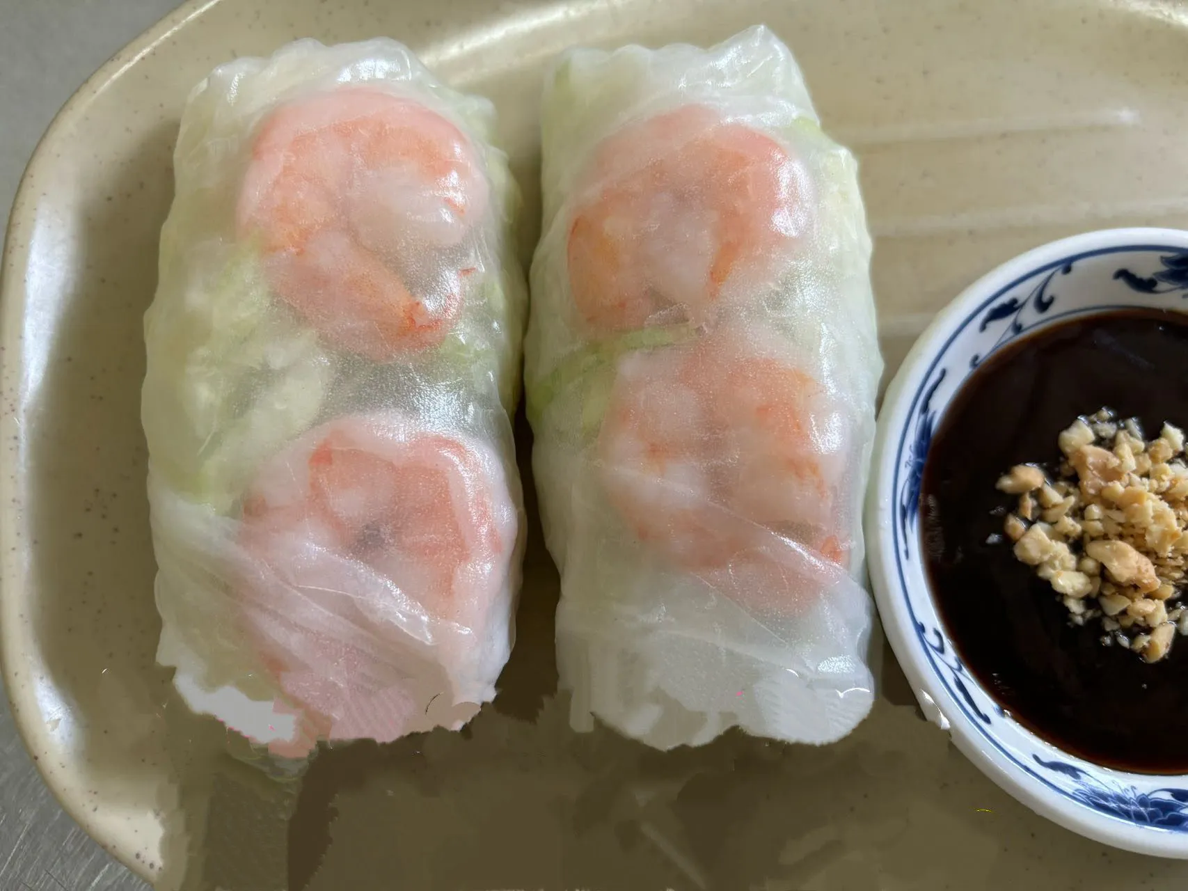 Two fresh shrimp rice paper spring rolls with dark peanut dipping sauce at The Wok, an Asian Fusion Restaurant in Rochester