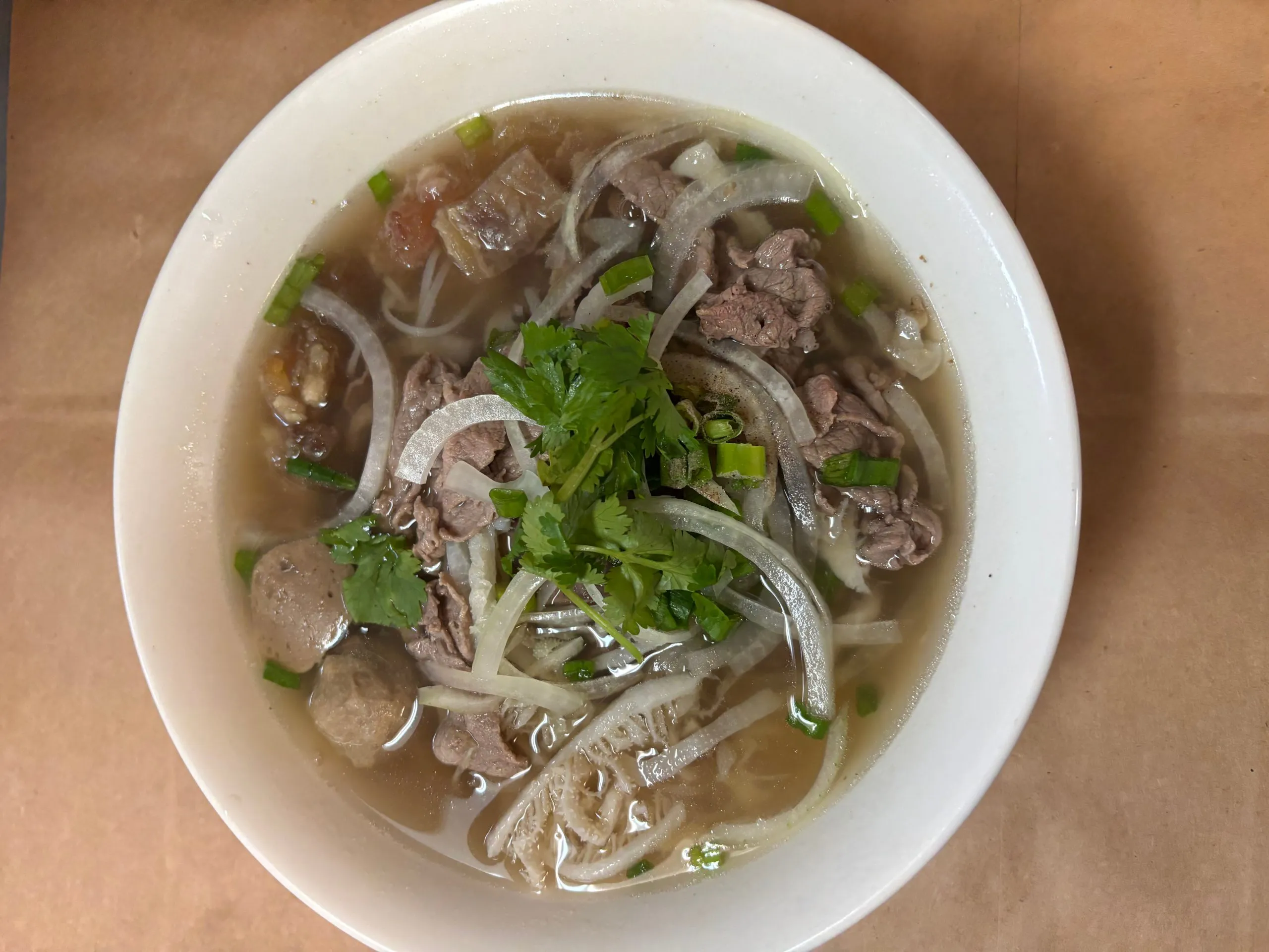 Traditional Vietnamese beef pho noodle soup garnished with bean sprouts and green onions at The Wok, an Asian Fusion Restaurant in Rochester
